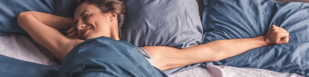 A young woman in bed having a good night's sleep